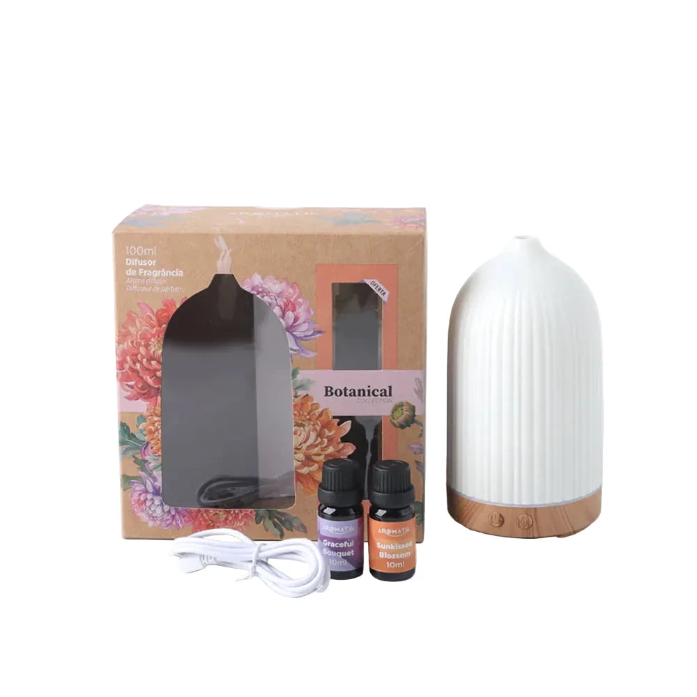 White diffuser with floral packaging, essential oils, and a cable on a white background