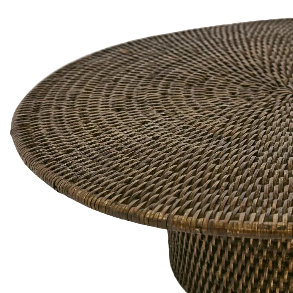 Close-up of a wicker table with a textured surface on a light gray background