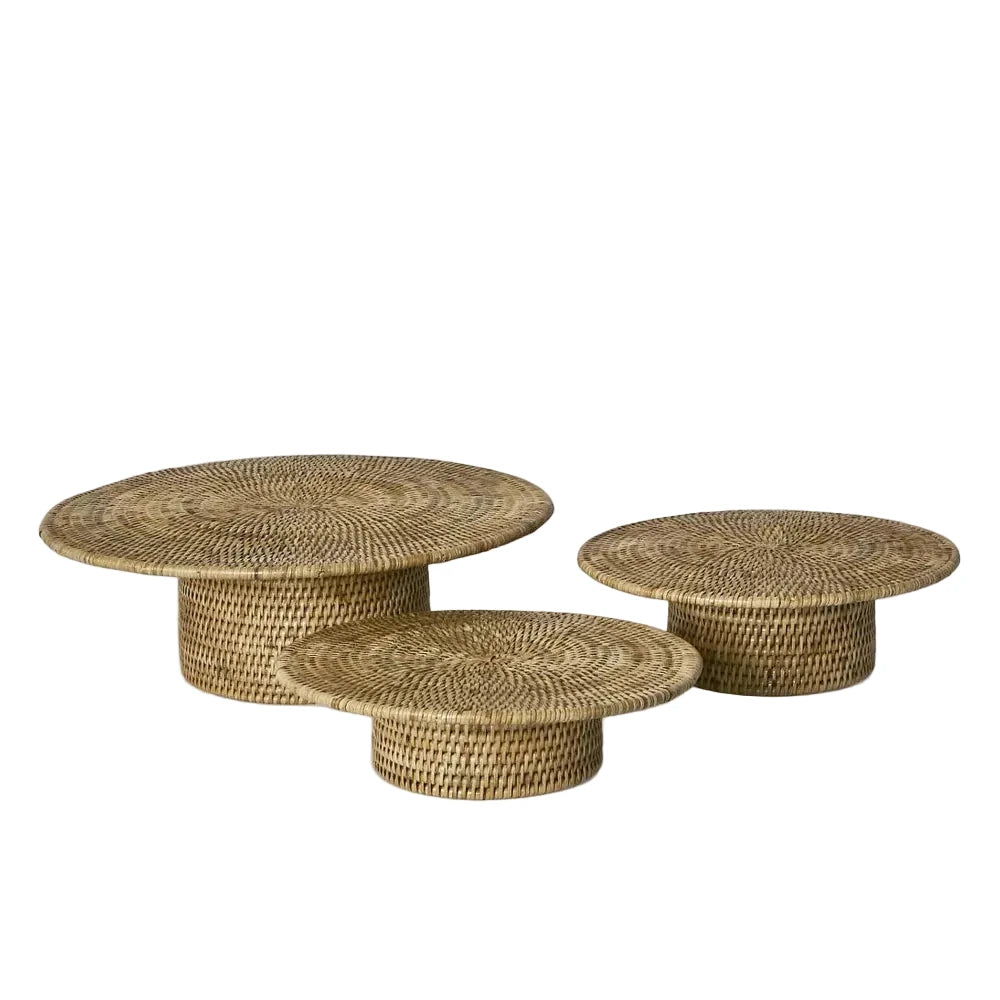 Set of three woven coffee tables on a white background