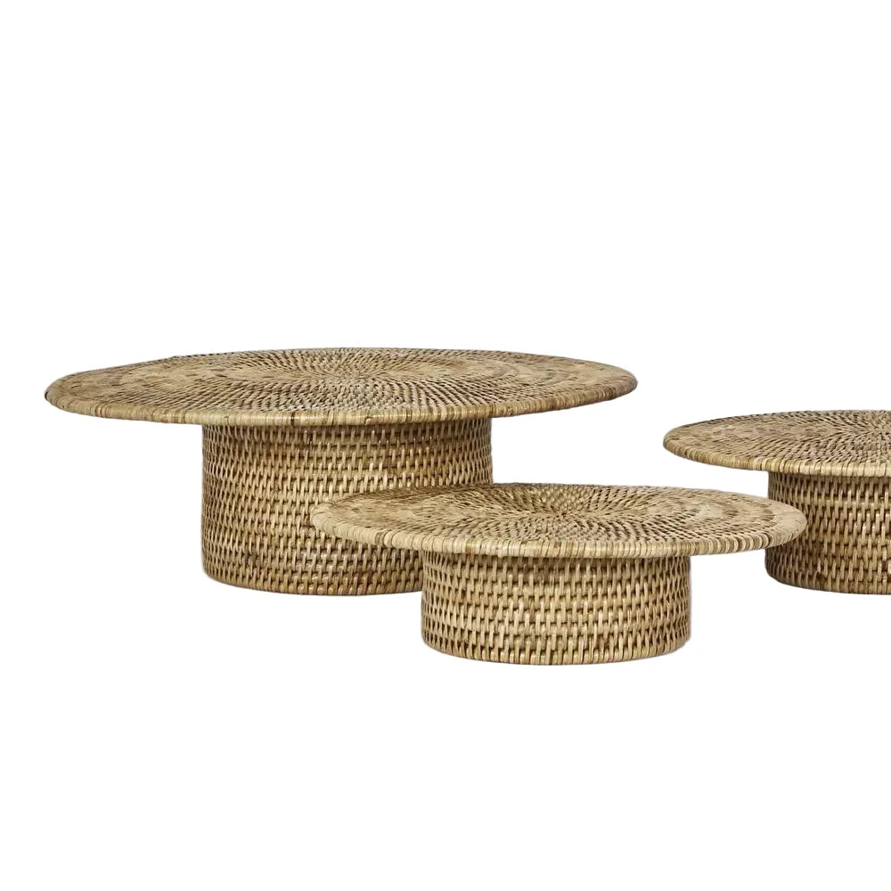 Set of three woven coffee tables on a light gray background