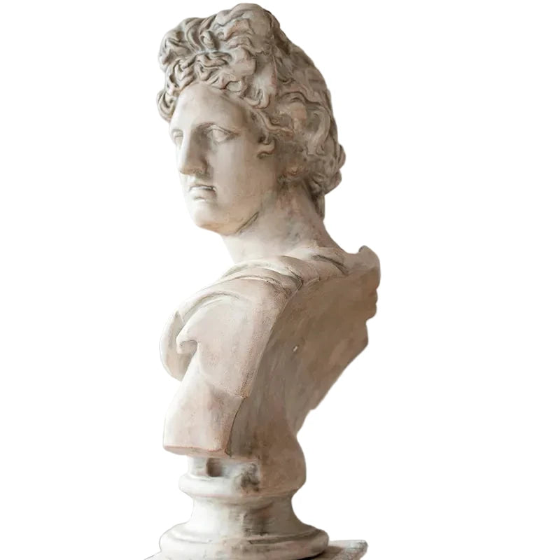 Statue bust of a classical figure against a neutral background