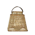 Woven basket with a handle on a light gray background