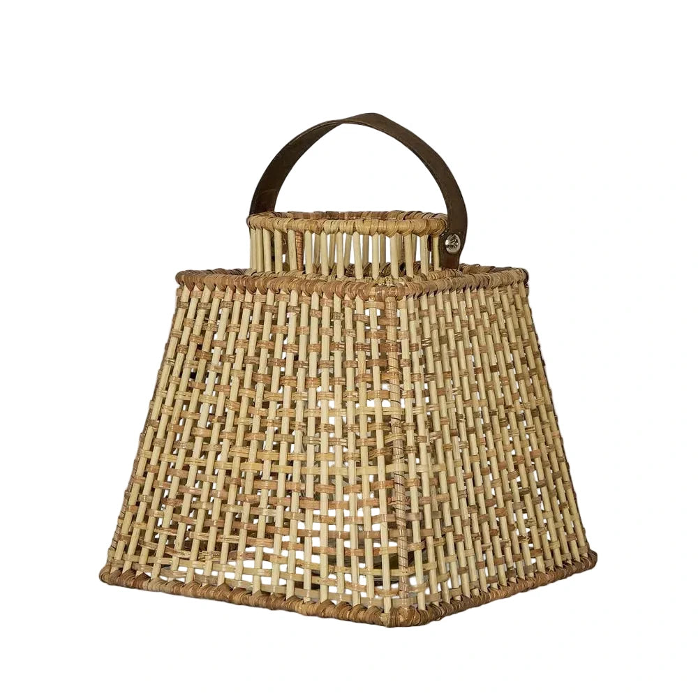 Woven basket with a handle on a light gray background