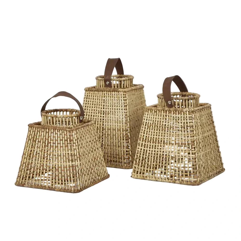 Three woven baskets with handles on a light gray background
