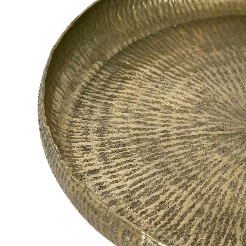 Close-up of a textured gold circular object on a white background