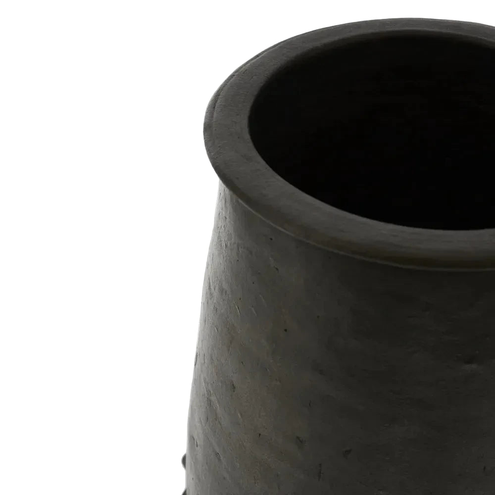 Black ceramic vase on a light gray background