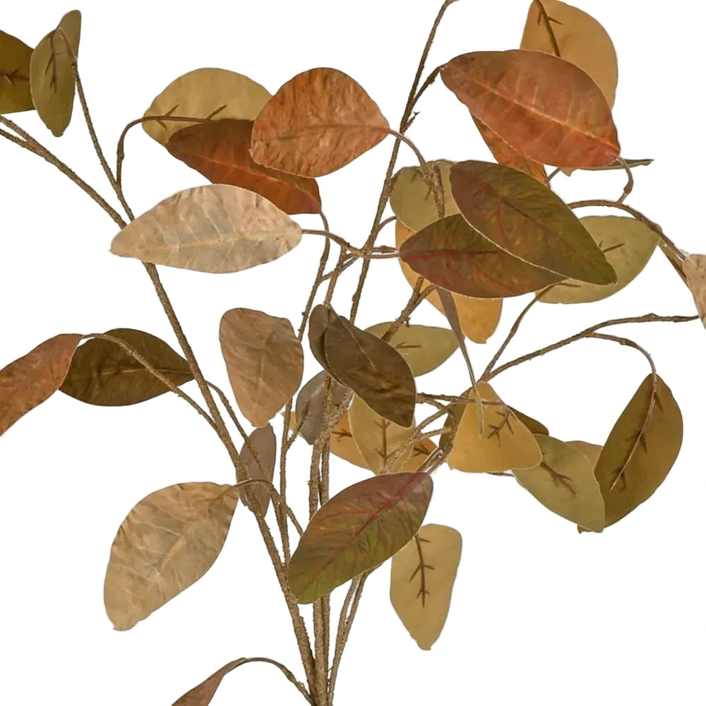 Artificial leaf branch with brown and green leaves on a white background
