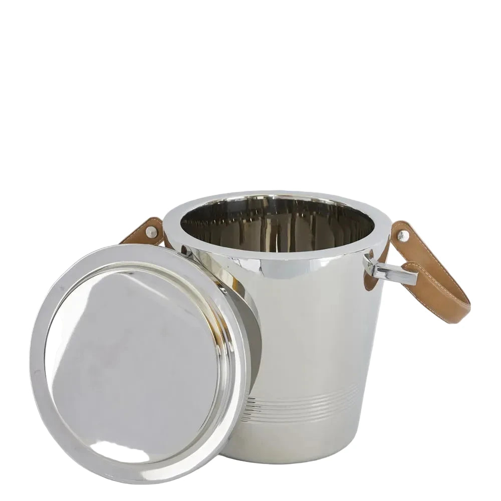 Silver ice bucket with brown leather handles on a light gray background