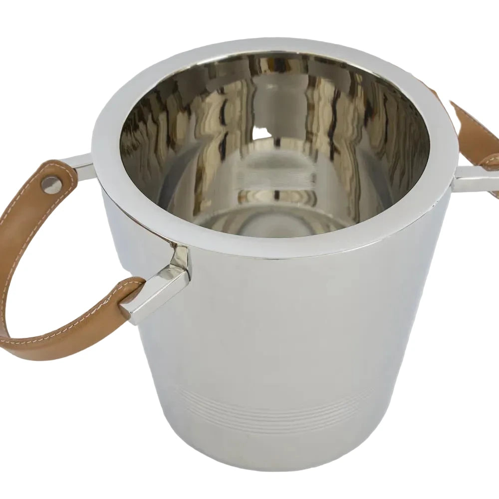 Stainless steel ice bucket with brown leather handles on a white background