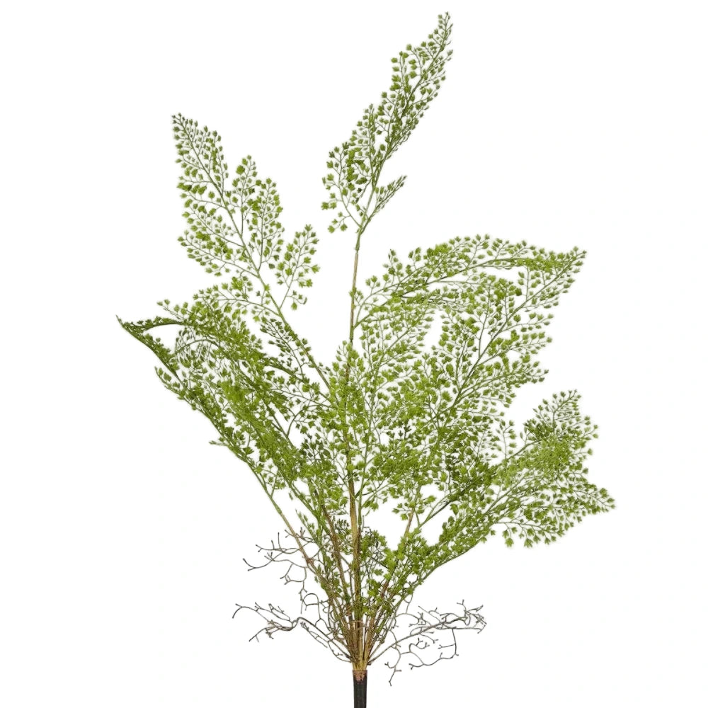Artificial green plant branch on a light gray background