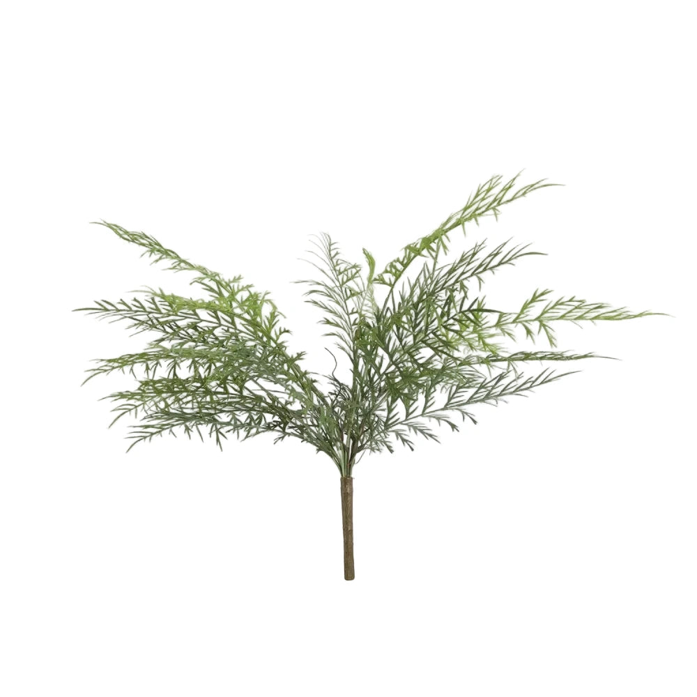 Artificial green plant branch on a light gray background