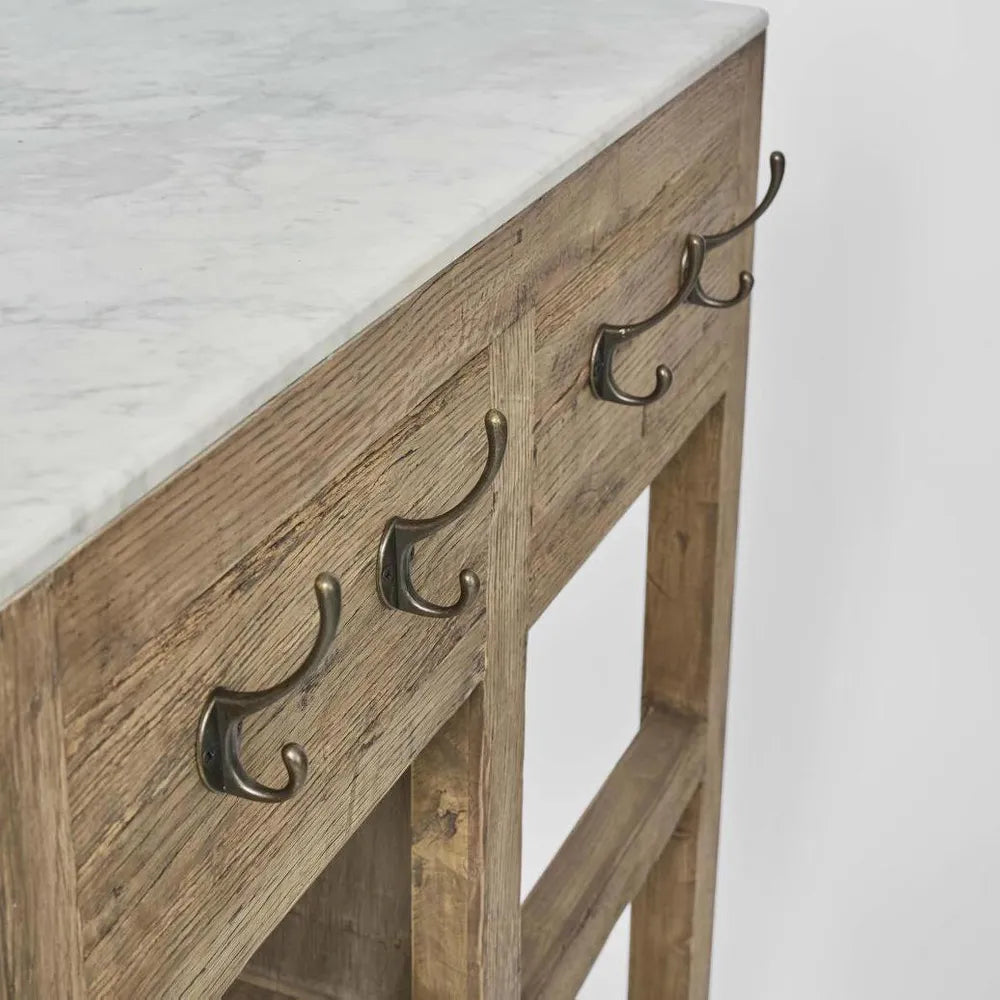 Wooden console table with marble top and brass hooks on a white background