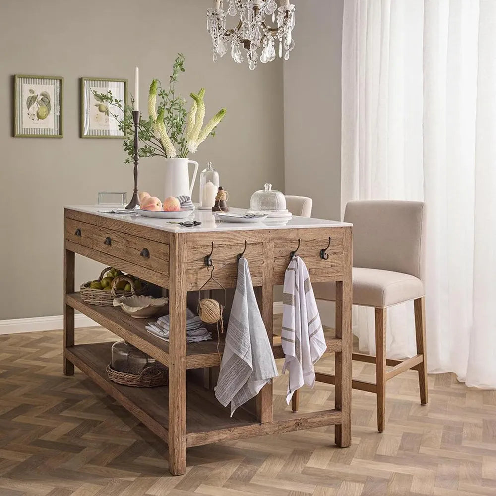 Dining room with wooden kitchen island, chairs, and decorative elements.