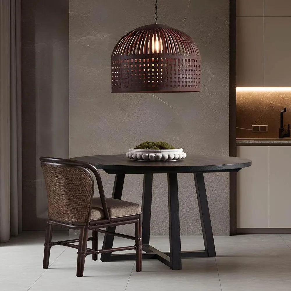 Dining area with a dark wooden table and chair, featuring a textured wall and pendant light.
