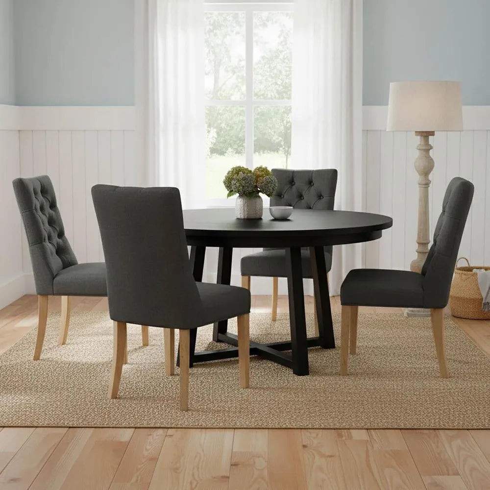 Dining room with a black oval table and gray chairs in a well-lit room.