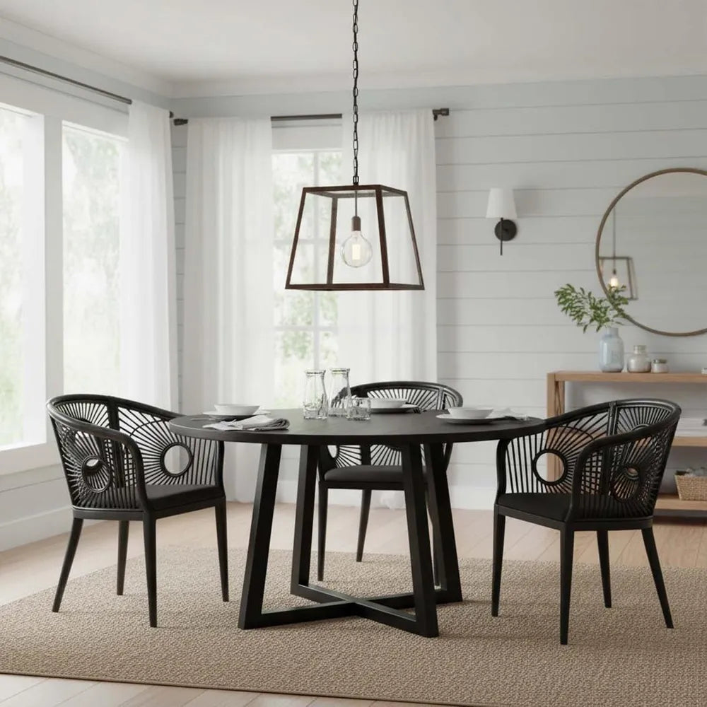 Dining room with a black round table and chairs, pendant light, and decor.
