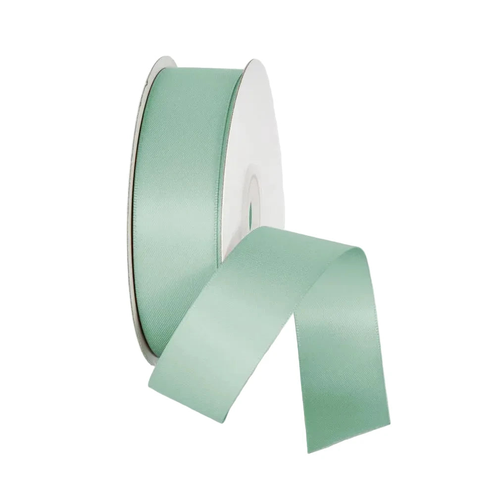 Spool of light green ribbon on a white background