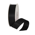 Spool of black ribbon on a light gray background
