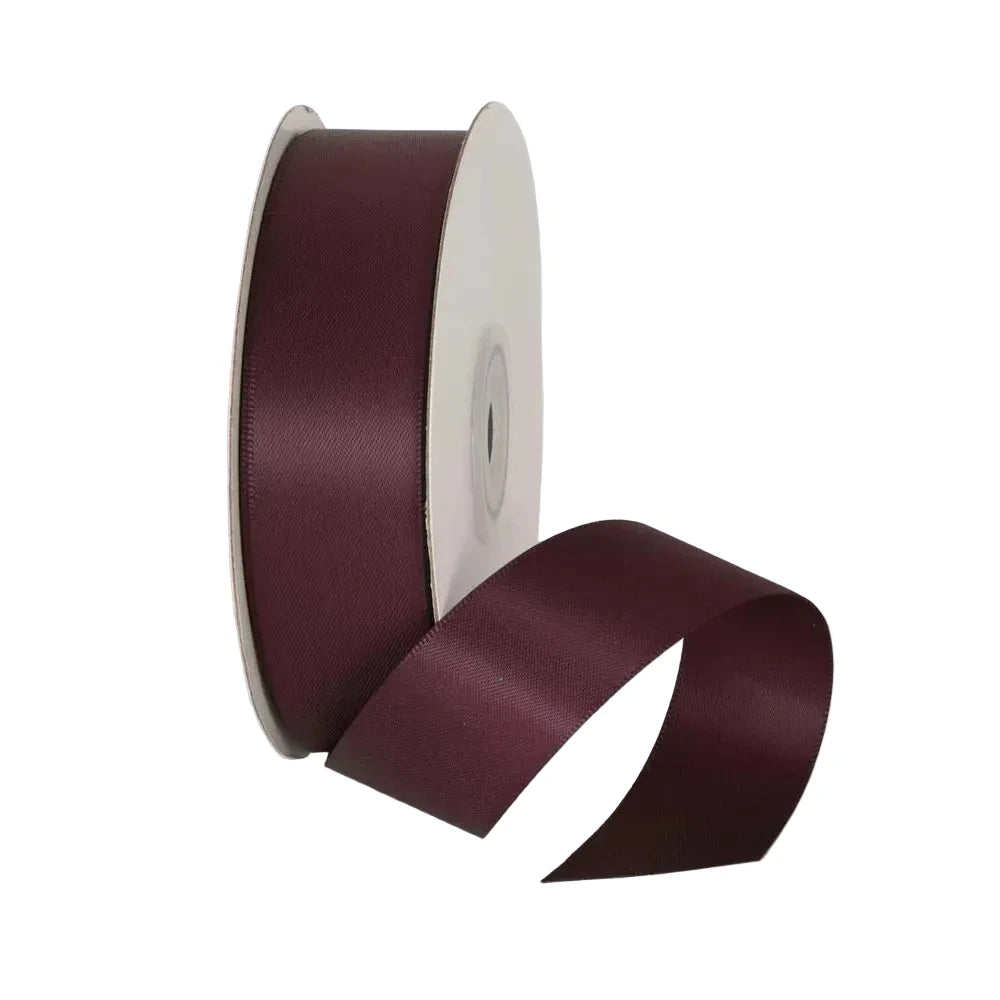 Maroon ribbon spool on a light gray background