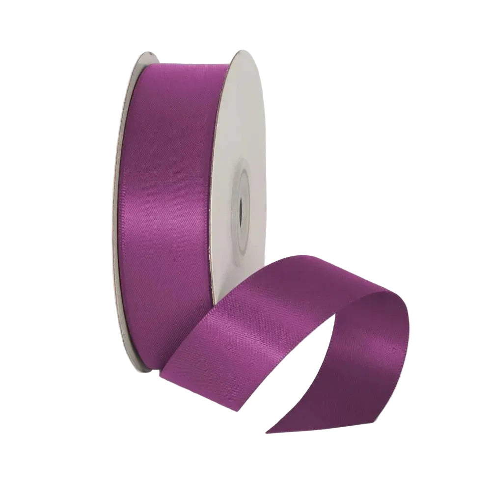 Purple ribbon spool on a white background