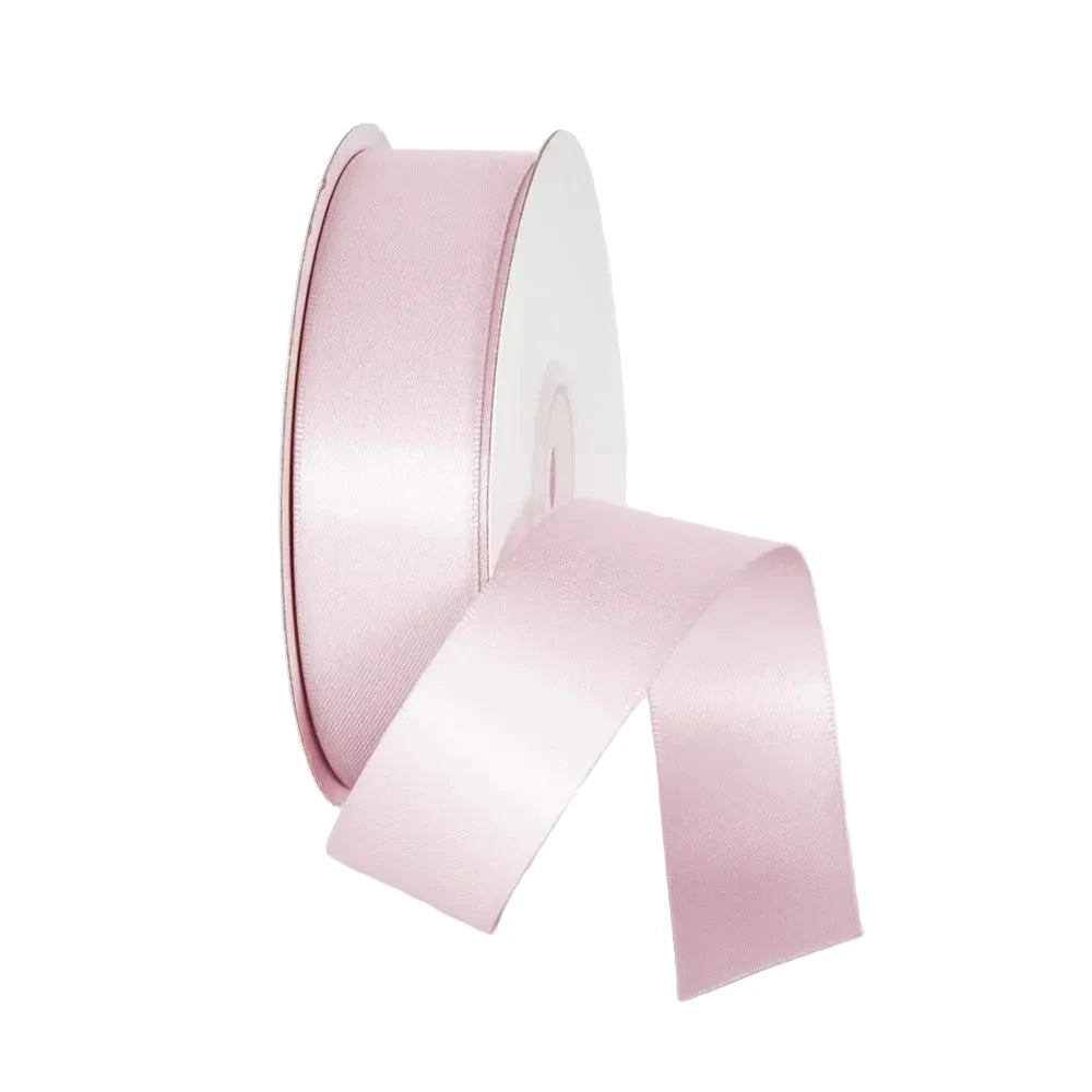 Pink satin ribbon on a light gray background
