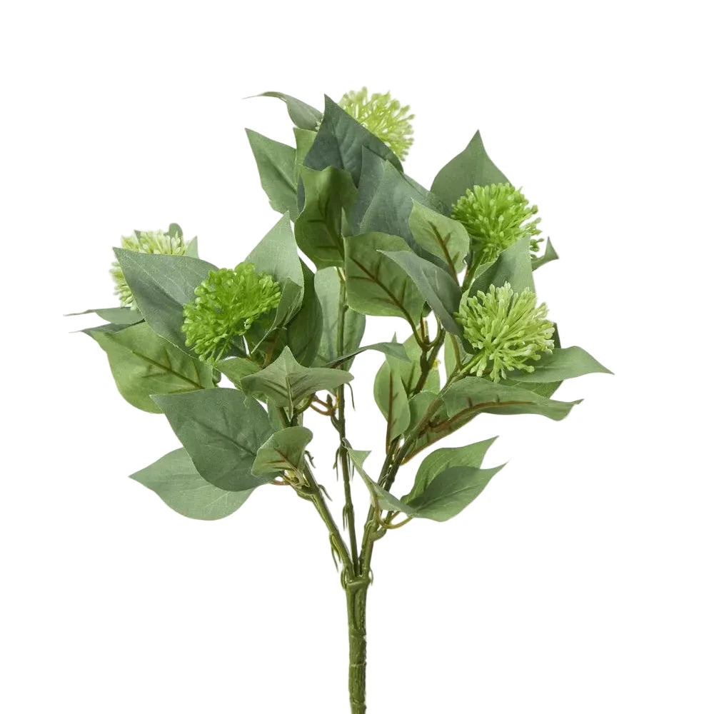 Artificial green leaf branch on a white background
