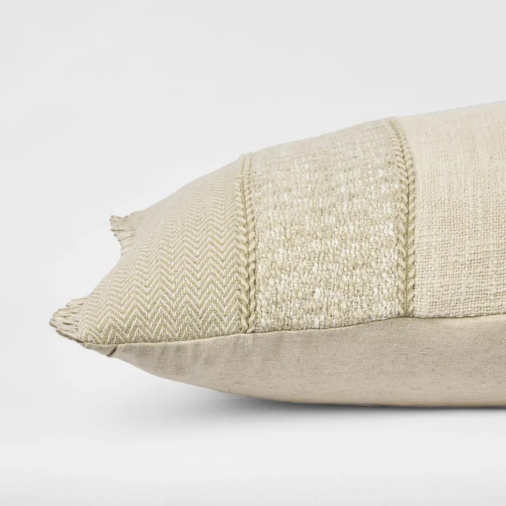 Textured beige pillow on a light gray background