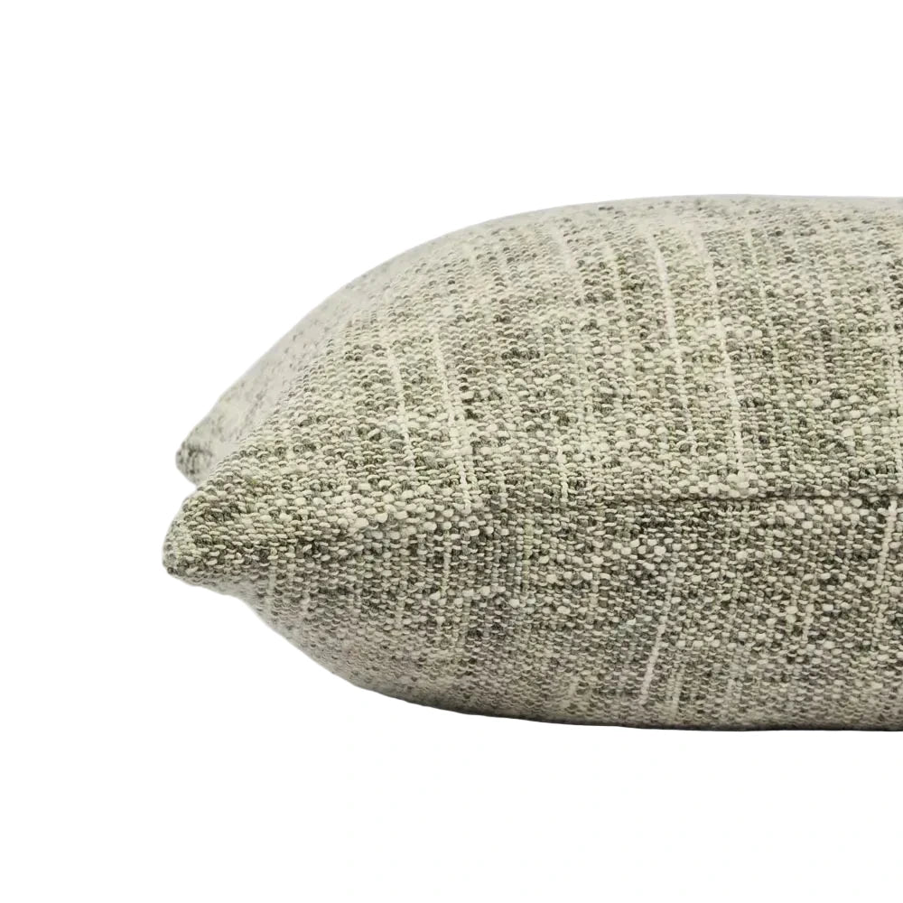 Textured green pillow on a light gray background