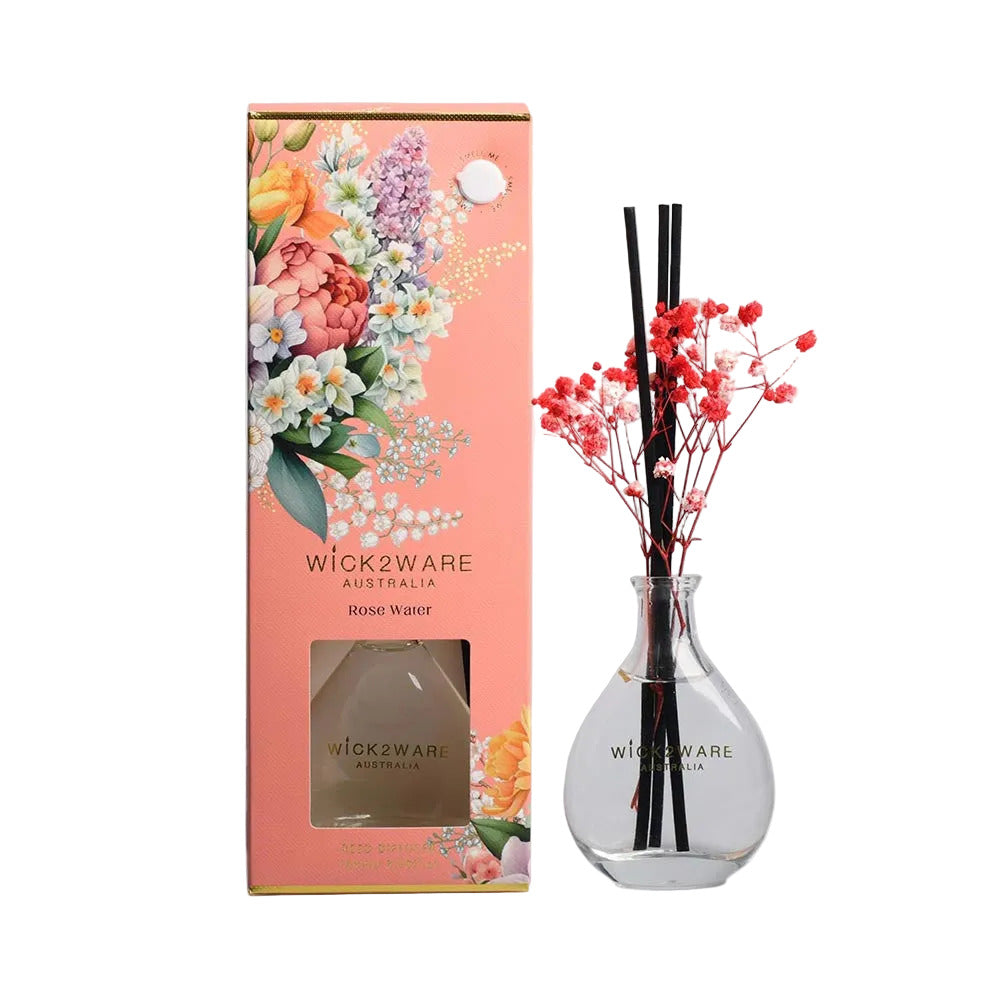 Wickware Australia diffuser set with floral packaging and clear vase with sticks and flowers.