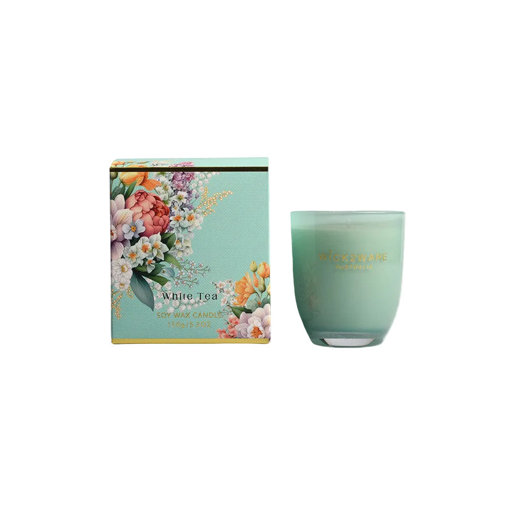 Green candle with floral packaging on a white background