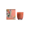 Candle and packaging with floral design on a white background