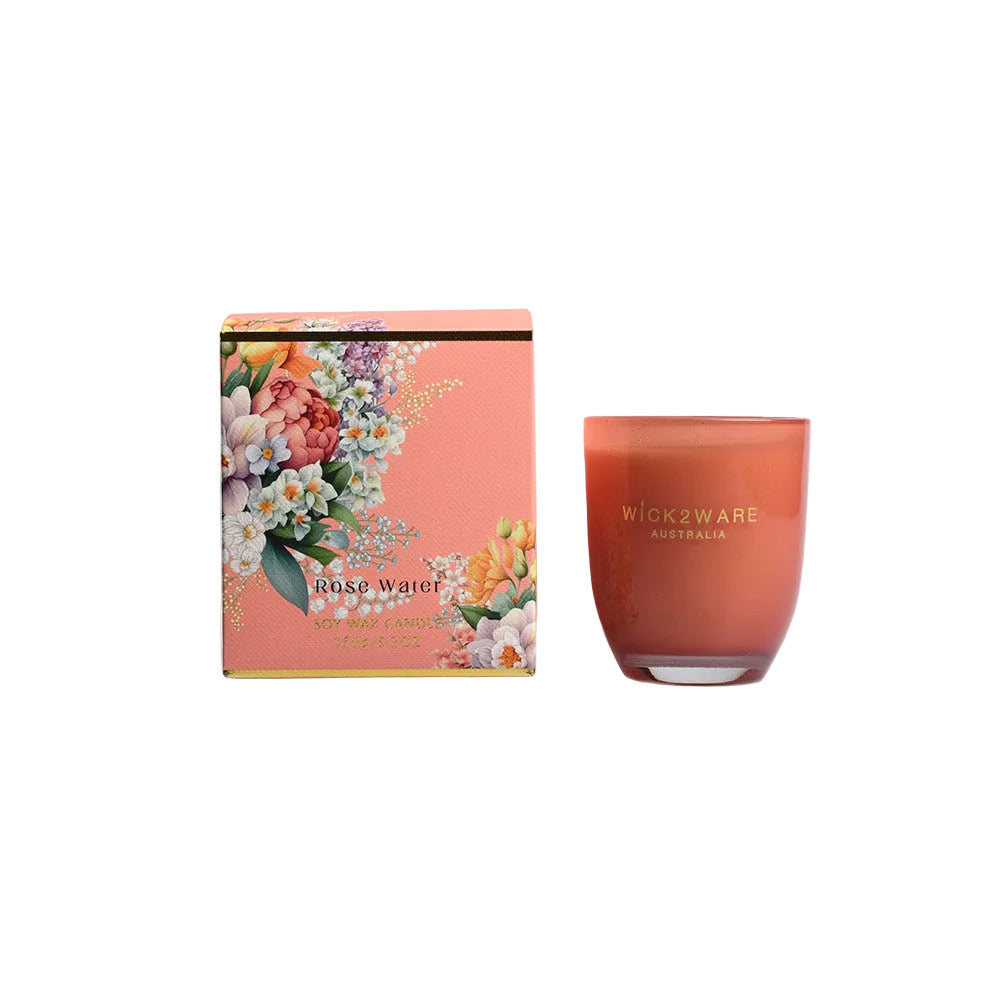 Candle and packaging with floral design on a white background