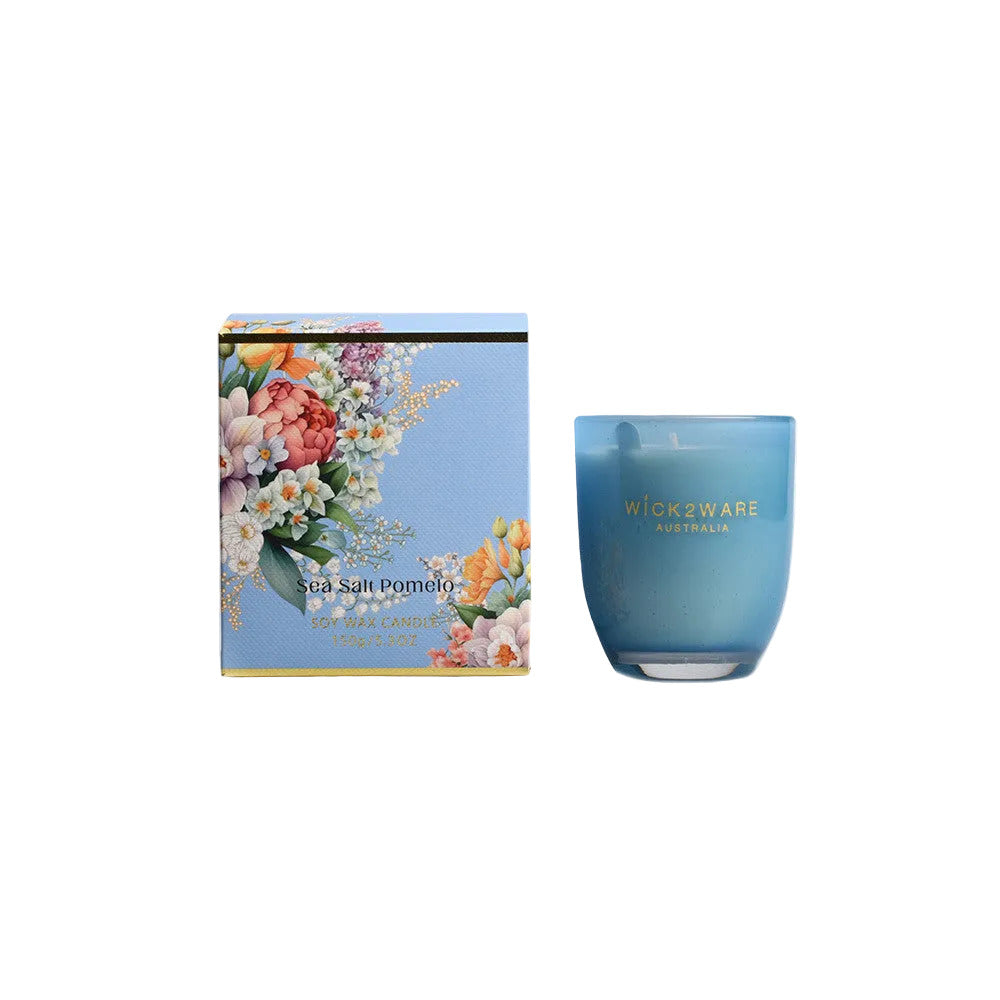 Blue candle with floral packaging on a white background