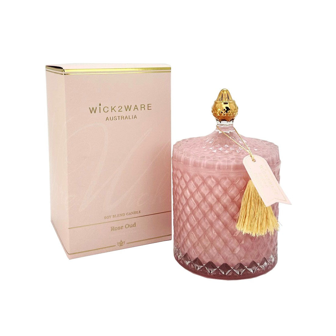 Pink candle with a gold cap and tassel next to a pink box labeled 'wick2ware Australia' on a white background.