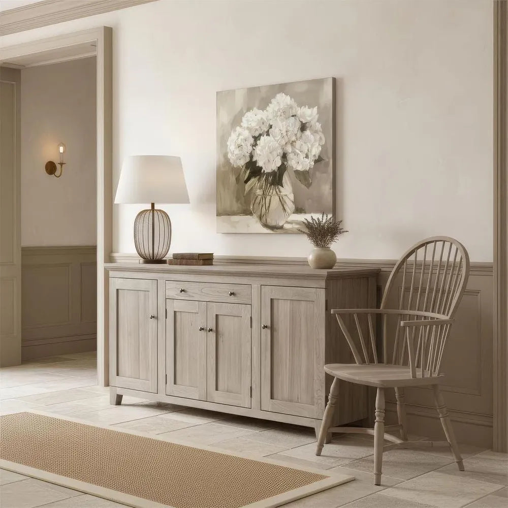 Light wood sideboard with chair and decorative items in a room setting