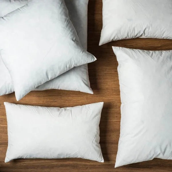 White pillows on a wooden surface