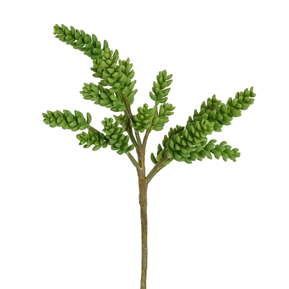 Artificial green plant branch on a white background