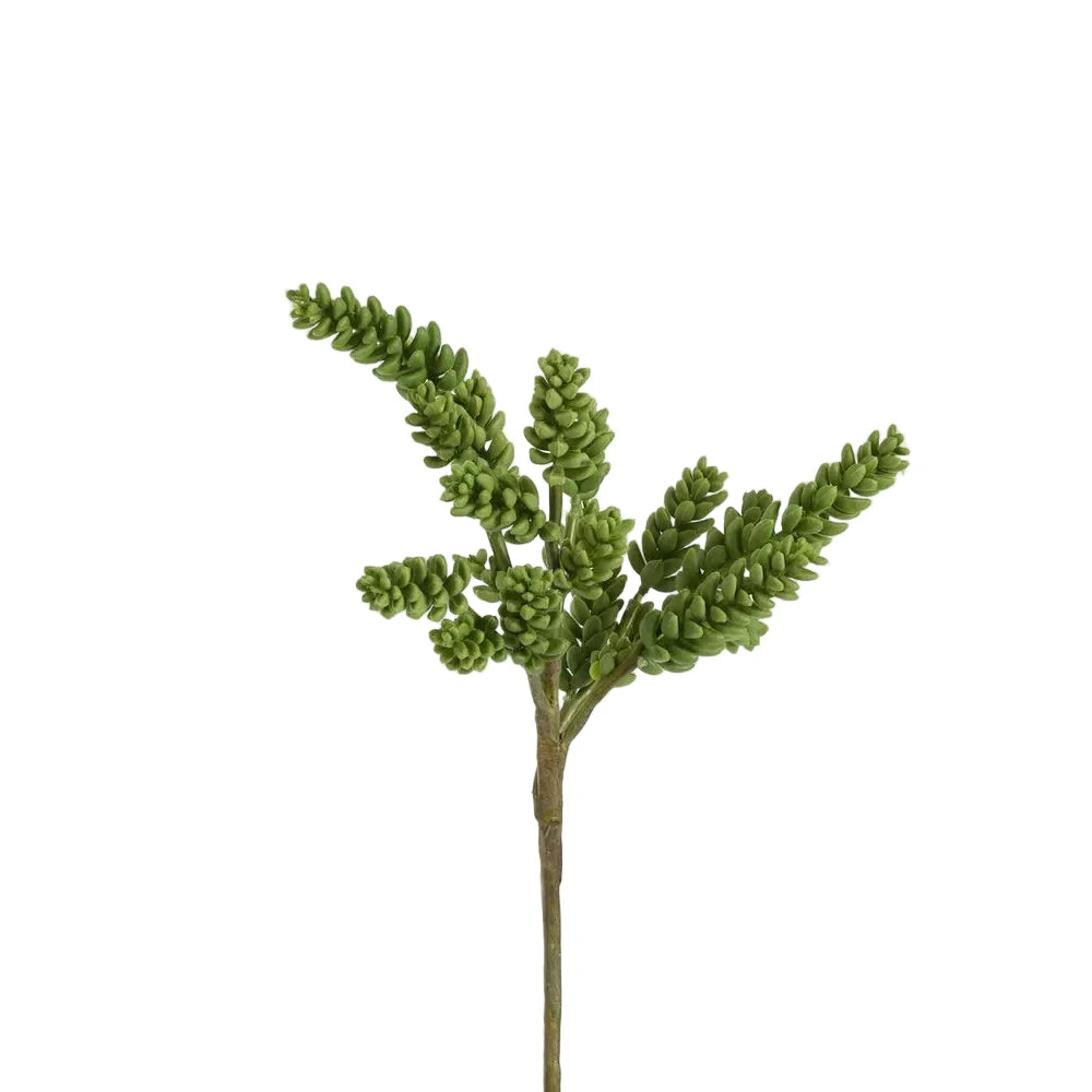 Artificial green plant branch on a white background