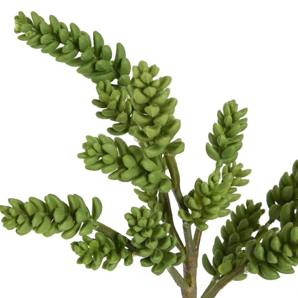 Artificial green plant branch on a white background