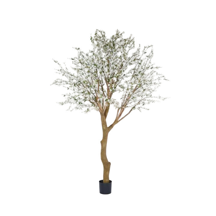 Artificial tree with green leaves in a pot on a white background