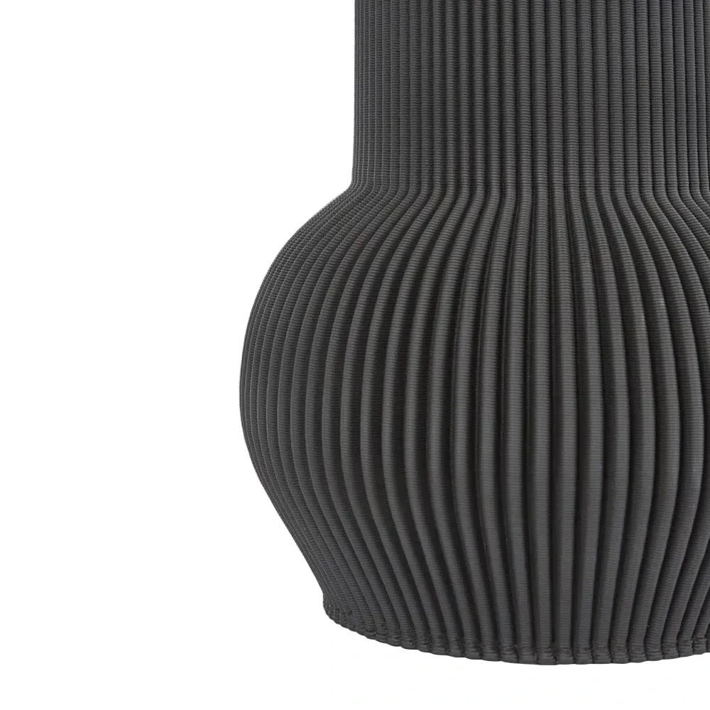Black ribbed vase on a light gray background