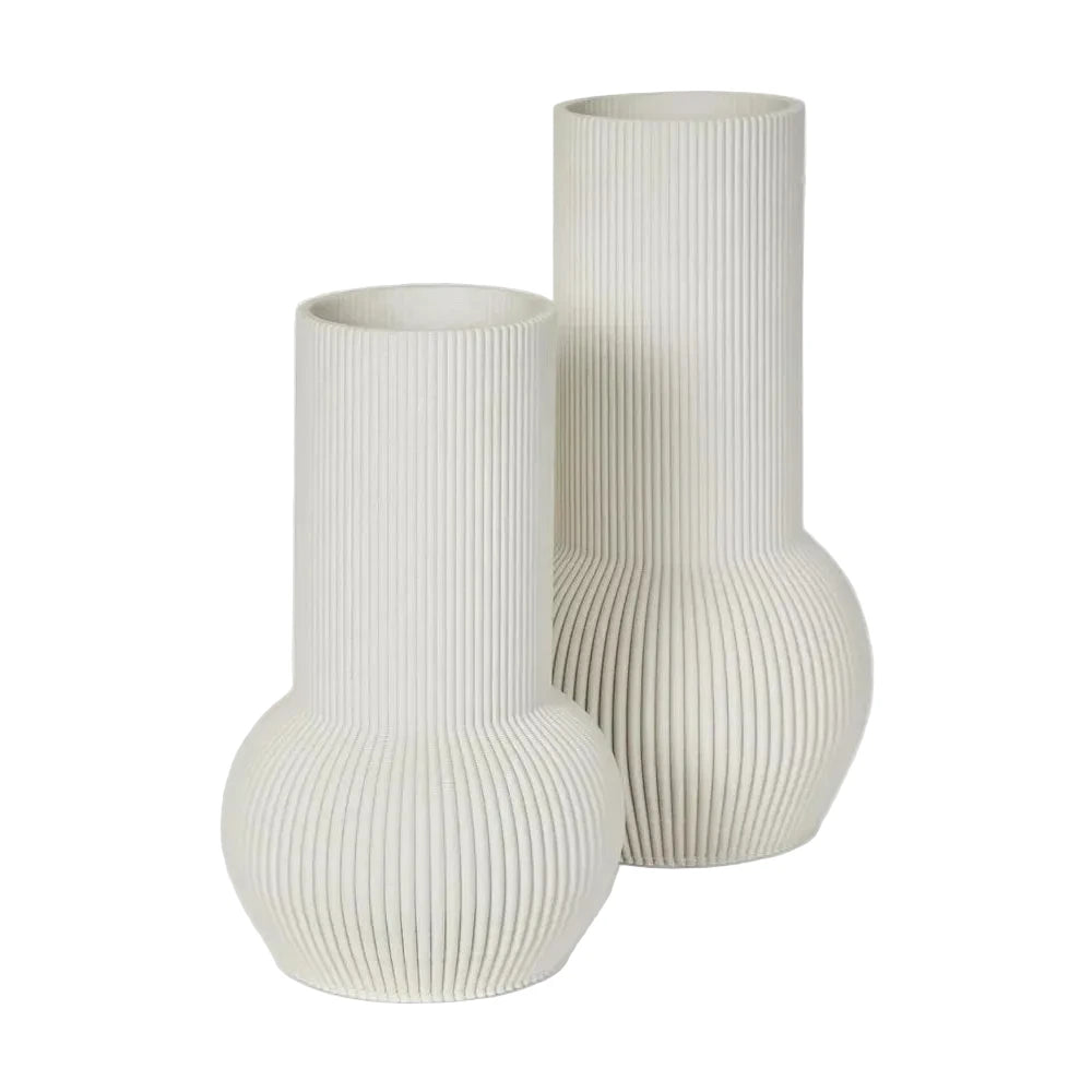Two ribbed ceramic vases on a light gray background